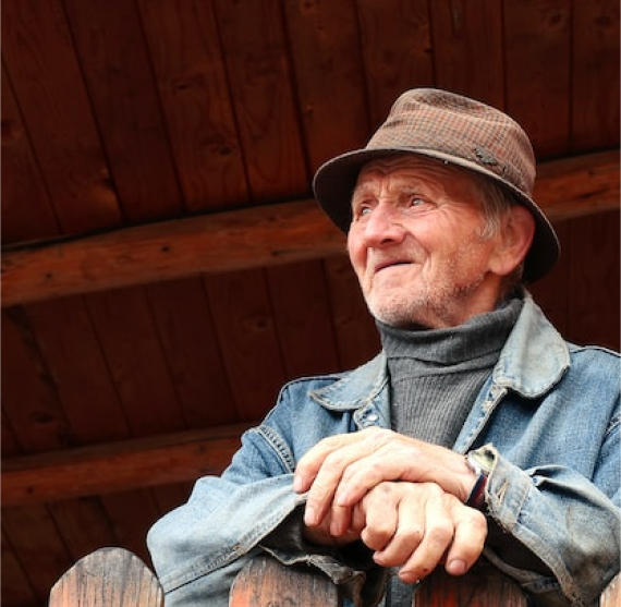 Aged man sitting on his porch
