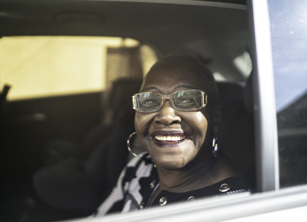 Elderly African woman looking out a car window